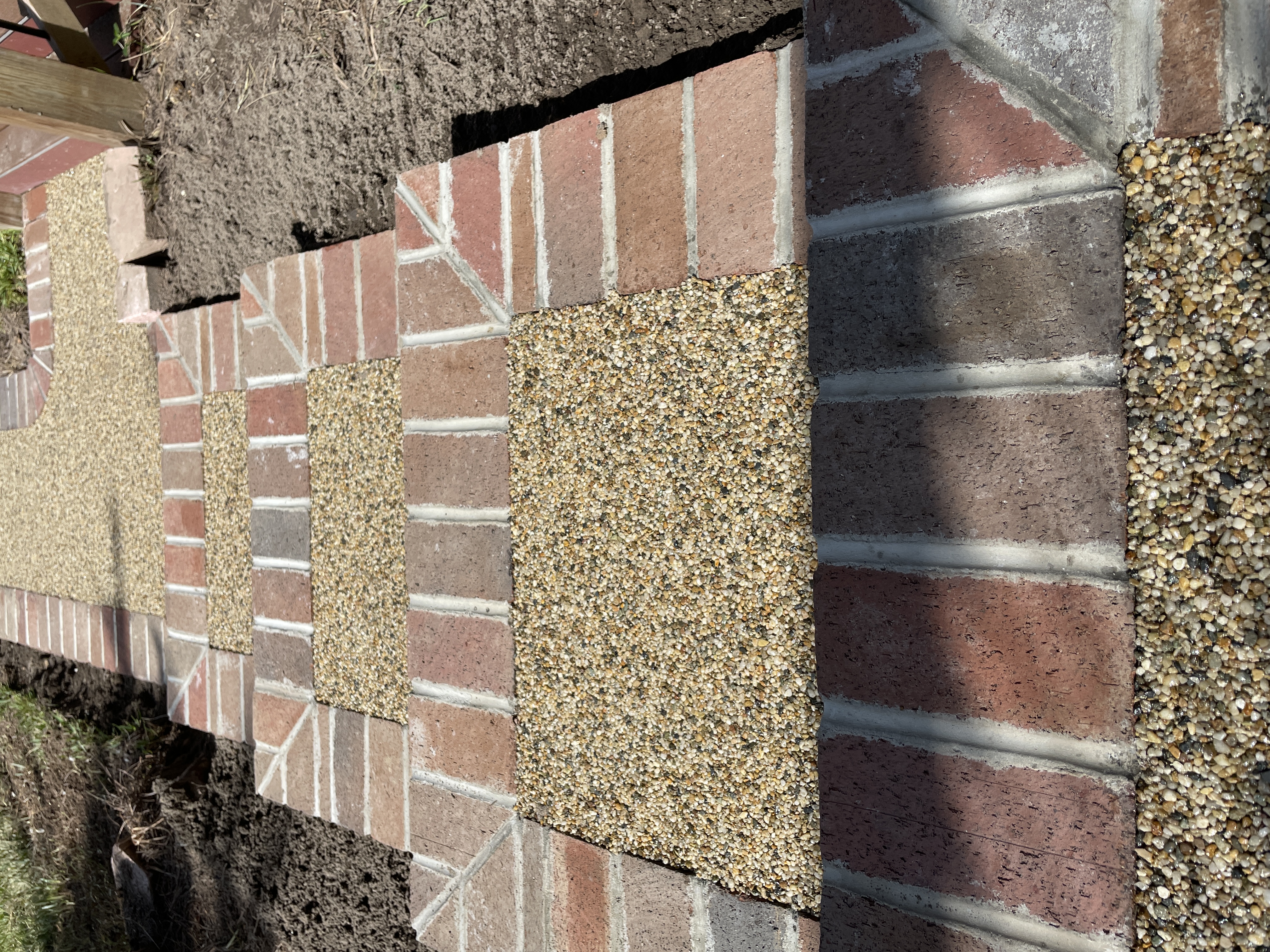 Brick and resin rock combo walkway installation close-up