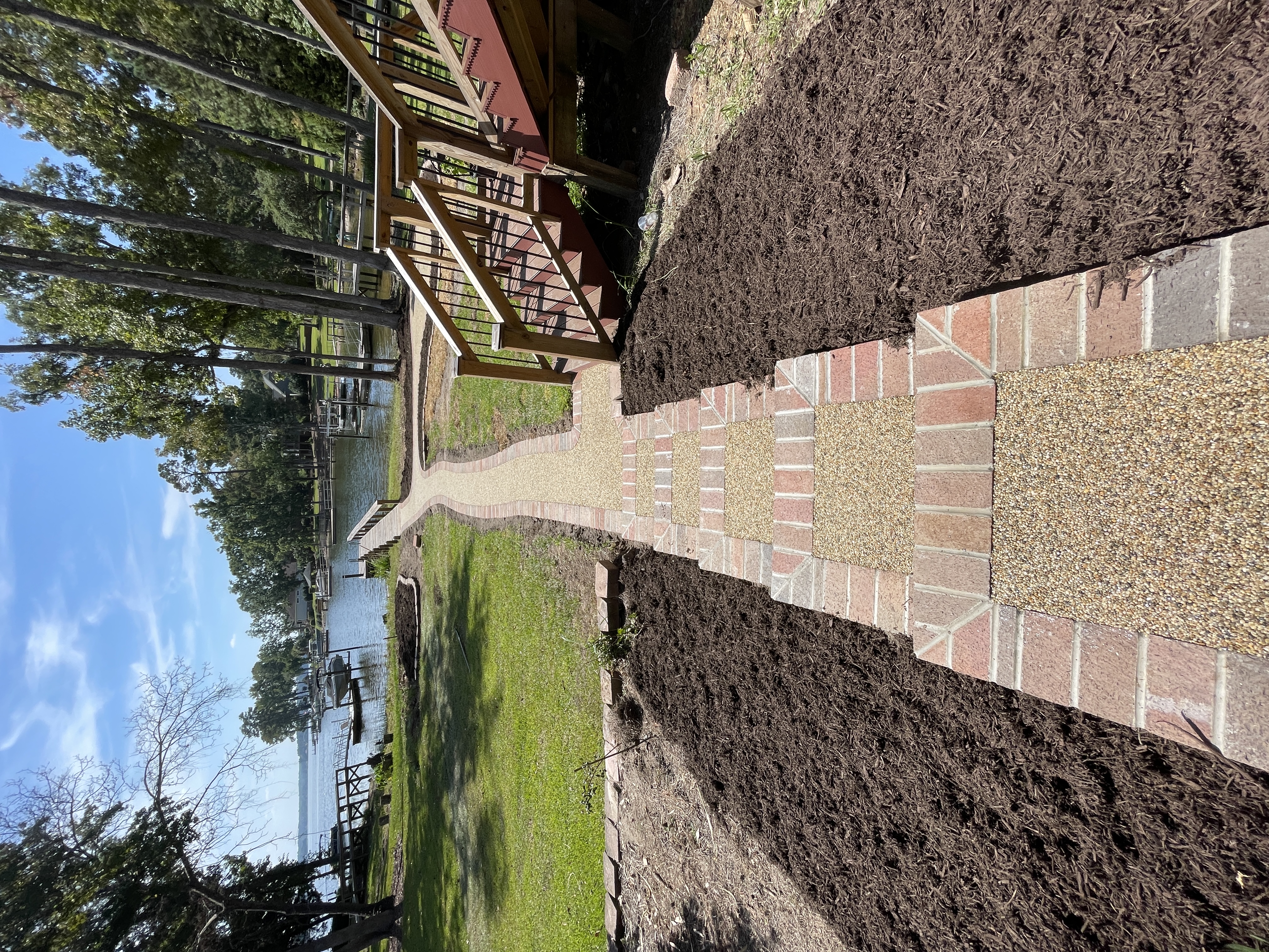 Resin rock and brick walkway leading to lakefront dock in South Carolina