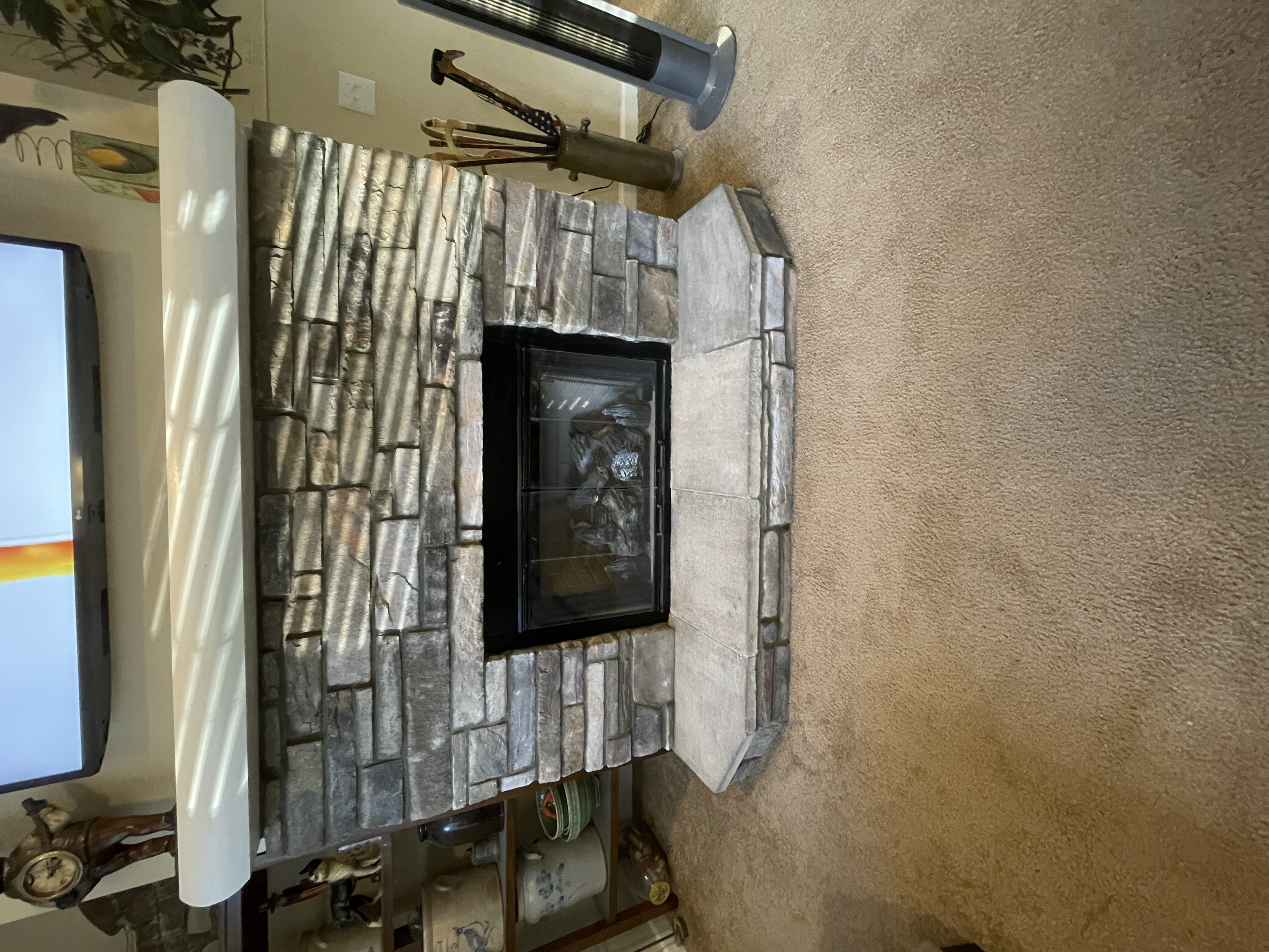 Custom interior stone fireplace surround with stacked stone veneer