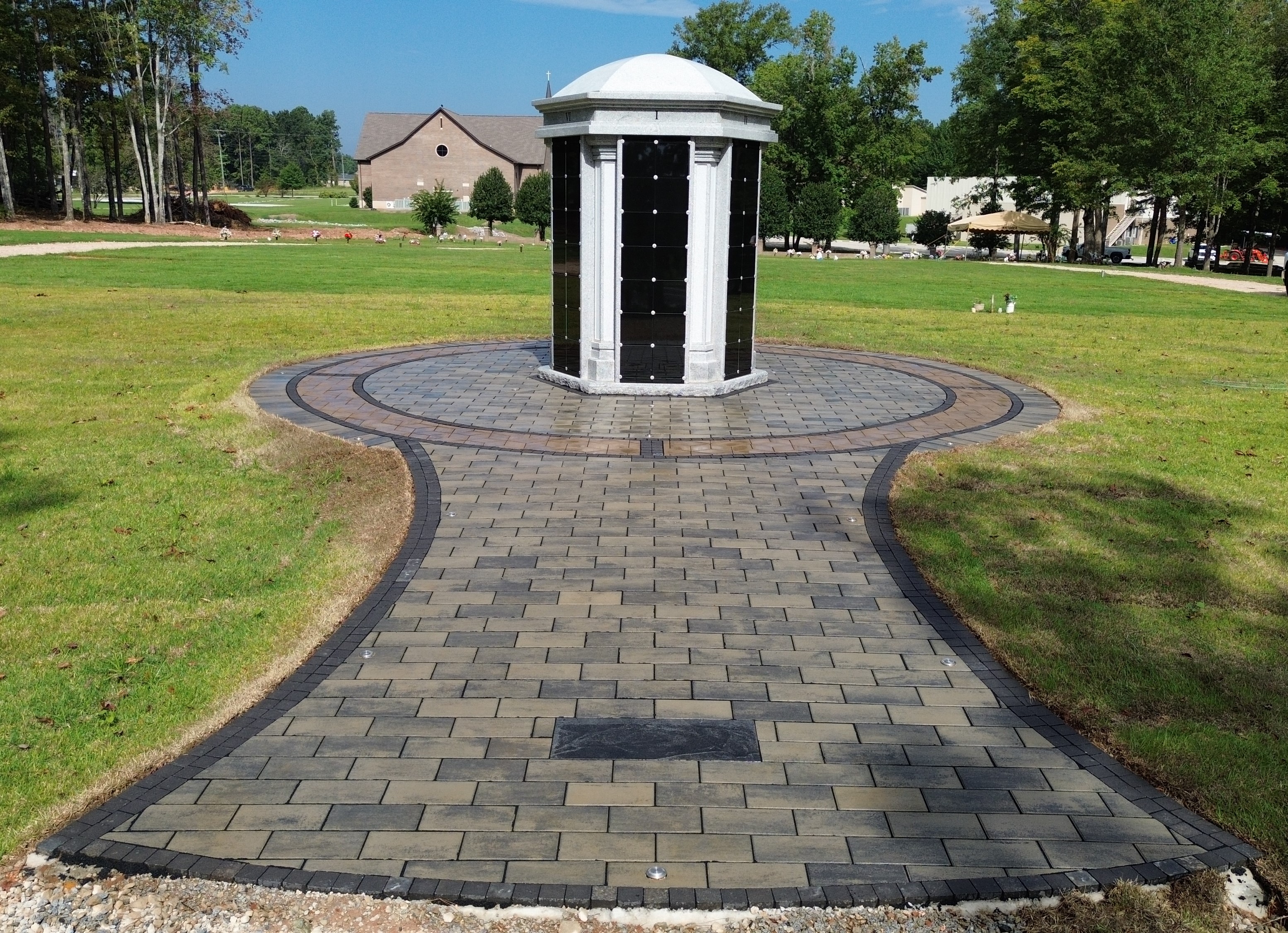 Circular paver plaza with decorative border installation