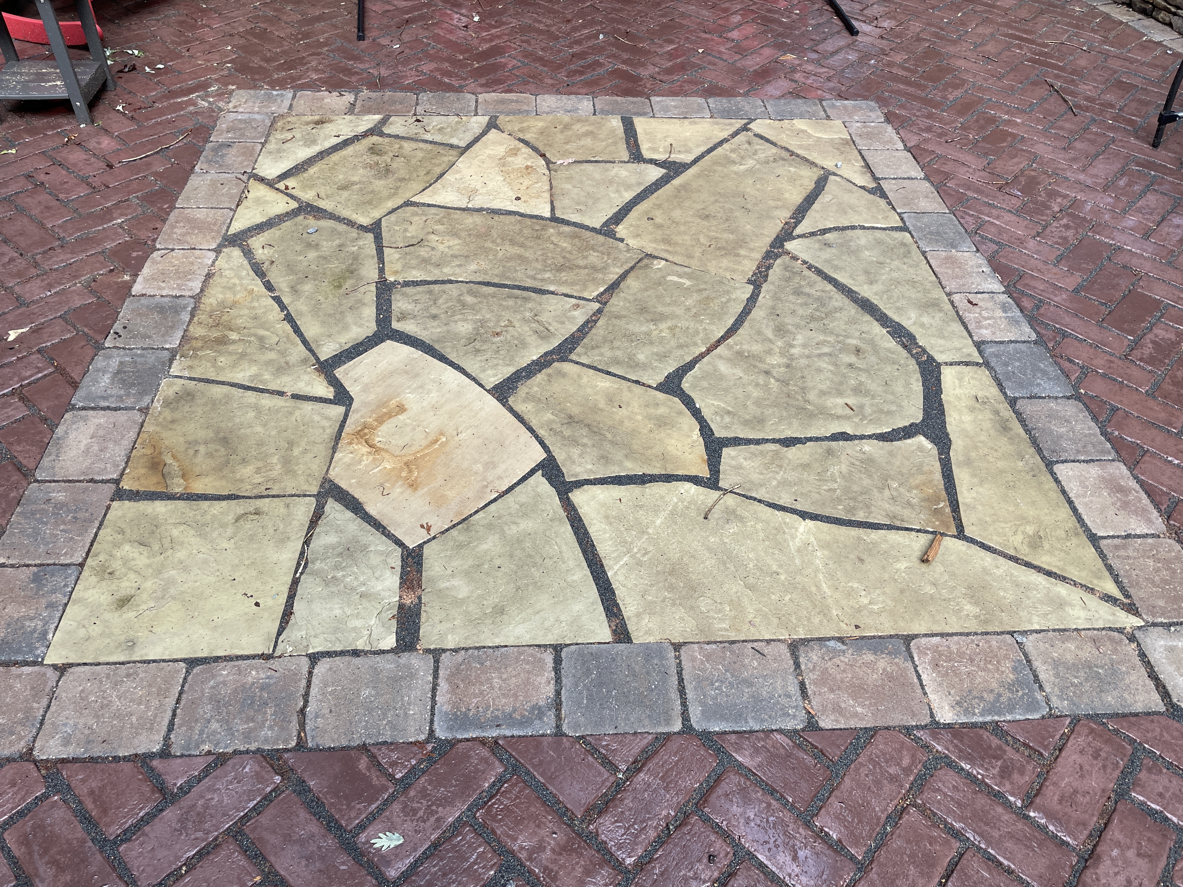 Flagstone inlay with brick paver surround
